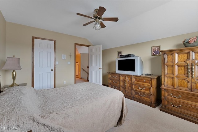 carpeted bedroom with a ceiling fan and lofted ceiling
