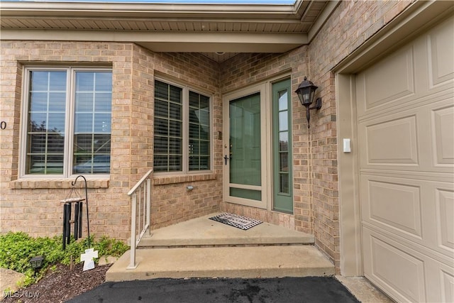 doorway to property featuring brick siding