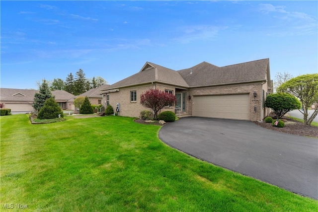 ranch-style house featuring brick siding, an attached garage, a front lawn, and aphalt driveway