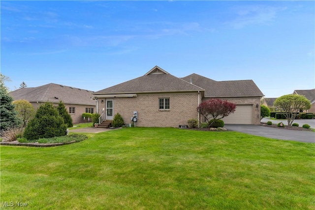exterior space featuring a lawn, brick siding, driveway, and a garage