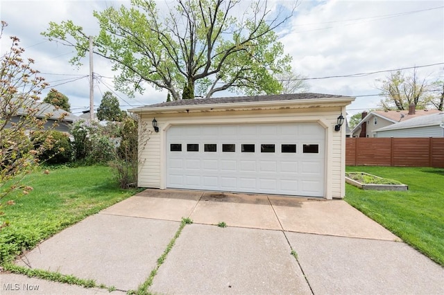 detached garage featuring fence