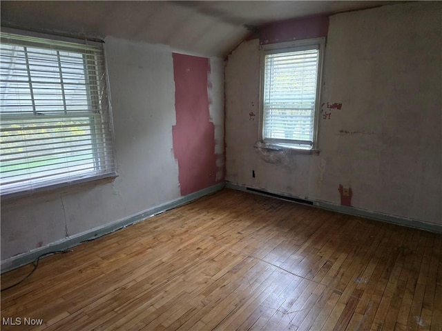 bonus room with lofted ceiling and hardwood / wood-style flooring