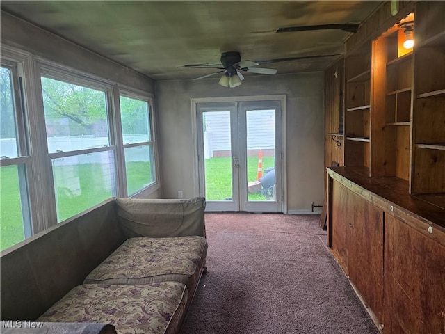 carpeted living area with ceiling fan