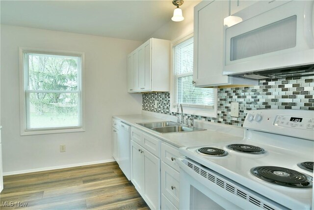 5071 Copeland Ave NW, Warren, OH 44483 - kitchen featuring a sink, a healthy amount of sunlight, white appliances, and light countertops