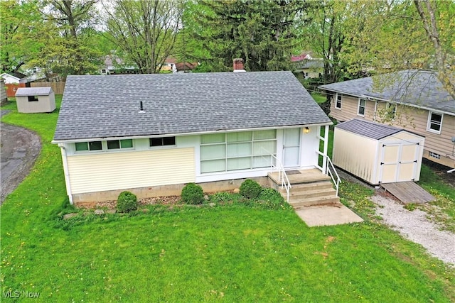 5071 Copeland Ave NW, Warren, OH 44483 - view of front facade with a storage shed, an outbuilding, a shingled roof, and a front lawn