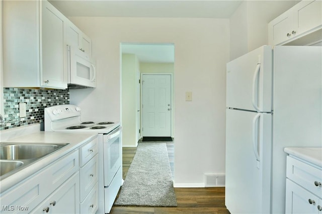 5071 Copeland Ave NW, Warren, OH 44483 - kitchen with light countertops, baseboards, white cabinets, white appliances, and dark wood-type flooring