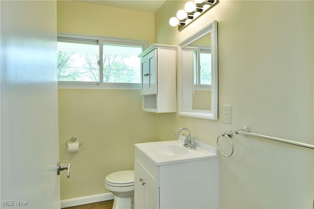 5071 Copeland Ave NW, Warren, OH 44483 - bathroom featuring vanity, plenty of natural light, baseboards, and toilet