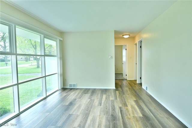 5071 Copeland Ave NW, Warren, OH 44483 - spare room featuring baseboards, visible vents, and wood finished floors