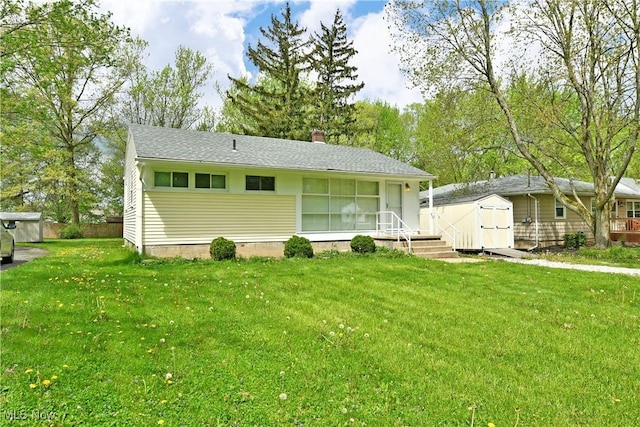5071 Copeland Ave NW, Warren, OH 44483 - view of front of house featuring a storage shed, a chimney, and a front yard