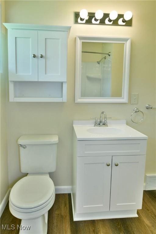 5071 Copeland Ave NW, Warren, OH 44483 - full bath featuring vanity, wood finished floors, toilet, baseboards, and walk in shower