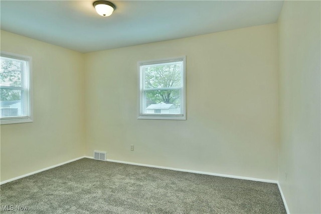 5071 Copeland Ave NW, Warren, OH 44483 - unfurnished room with visible vents, baseboards, and dark carpet