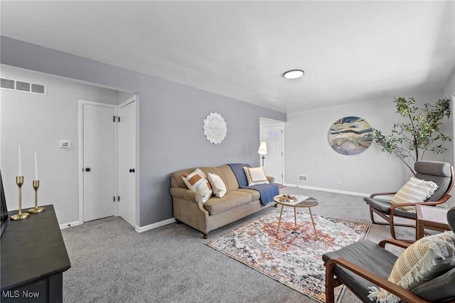 living room with carpet floors, baseboards, and visible vents
