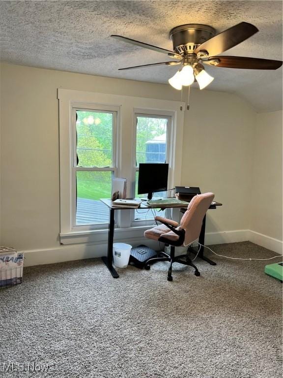 office featuring a textured ceiling, baseboards, ceiling fan, and carpet