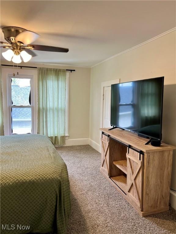 bedroom featuring baseboards, ornamental molding, a ceiling fan, and carpet flooring
