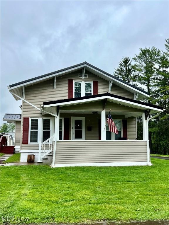 bungalow-style house with a porch and a front lawn