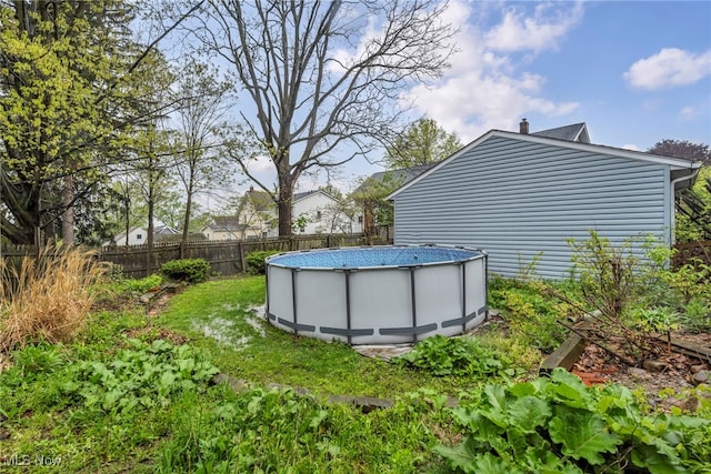 view of yard featuring a fenced in pool and fence