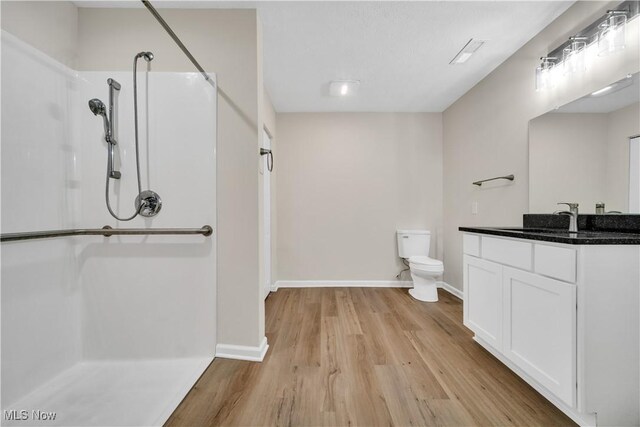 5164 Langfitt St, Vermilion, OH 44089 - bathroom with a shower, vanity, wood finished floors, toilet, and baseboards