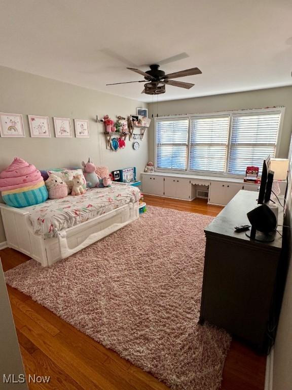bedroom featuring a ceiling fan and wood finished floors