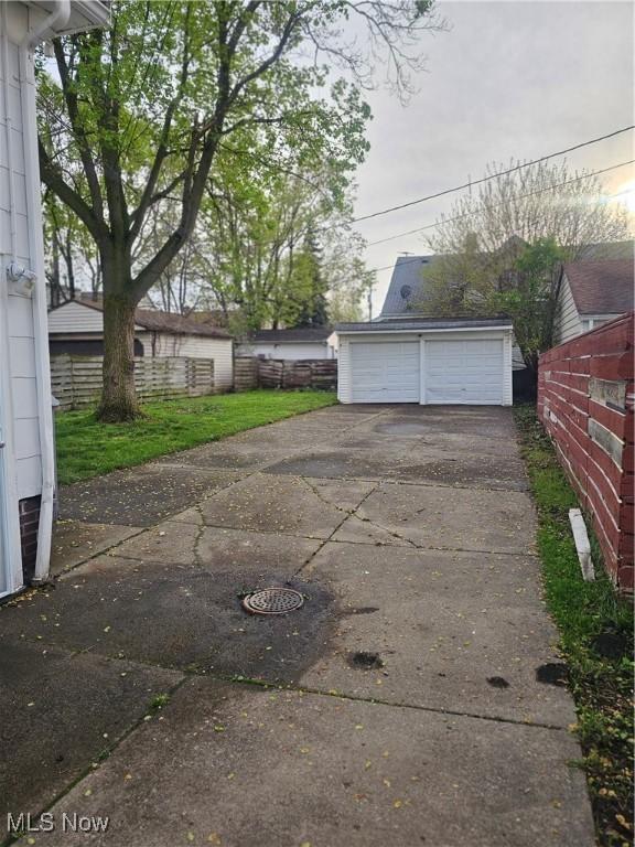 detached garage featuring fence