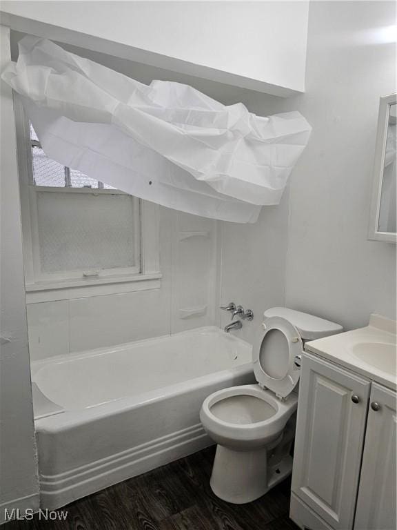 bathroom with vanity, bathtub / shower combination, toilet, and wood finished floors