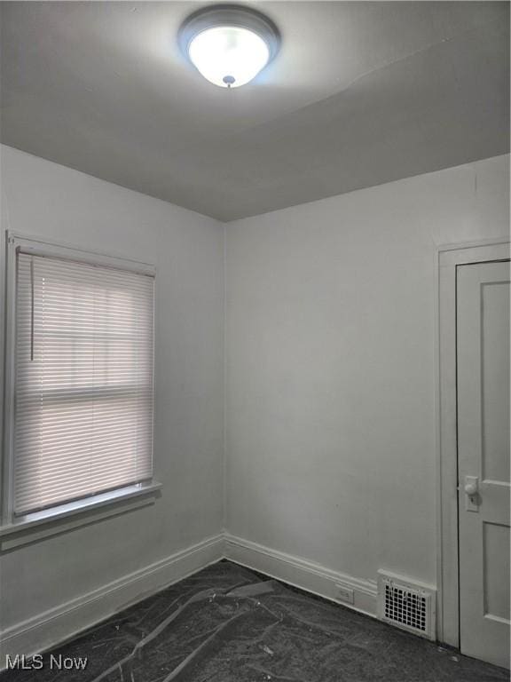 unfurnished room with baseboards, visible vents, and marble finish floor
