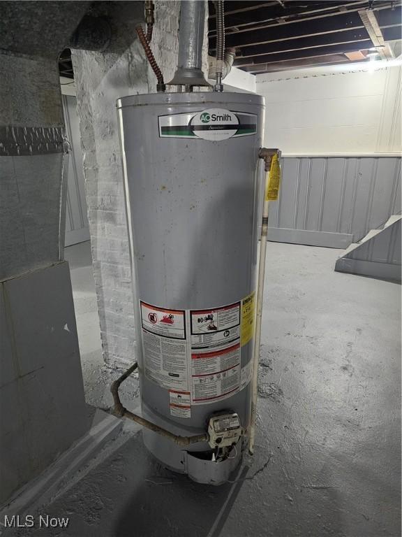 utility room with gas water heater