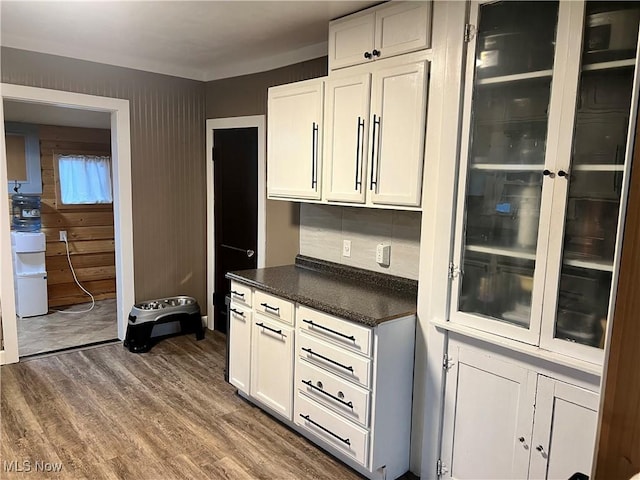 kitchen with glass insert cabinets, white cabinets, backsplash, and dark wood-style floors