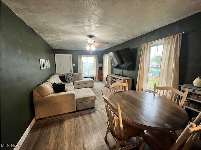 dining space featuring a ceiling fan, baseboards, a wealth of natural light, and light wood-style flooring