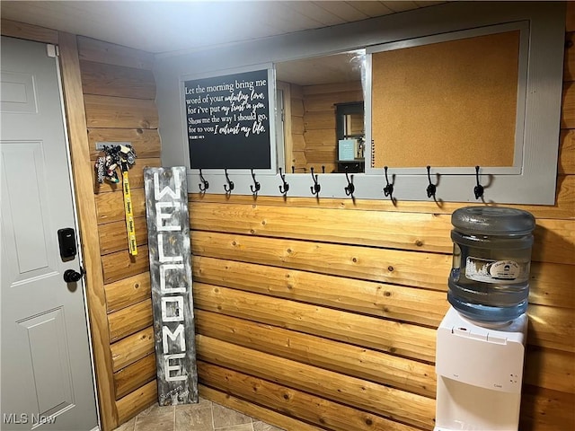 mudroom featuring wooden walls