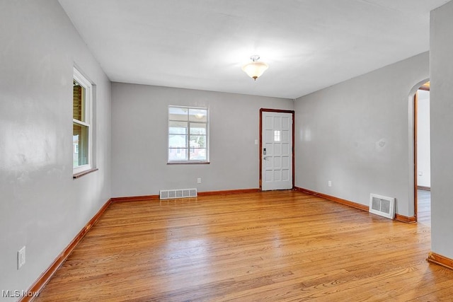 23267 Marion Rd, North Olmsted, OH 44070 - interior space featuring visible vents, arched walkways, light wood-style floors, and baseboards