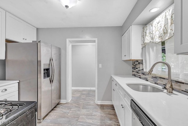 23267 Marion Rd, North Olmsted, OH 44070 - kitchen with white cabinetry, baseboards, a sink, and tasteful backsplash