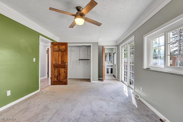 23267 Marion Rd, North Olmsted, OH 44070 - unfurnished bedroom with crown molding, carpet floors, a closet, and a textured ceiling