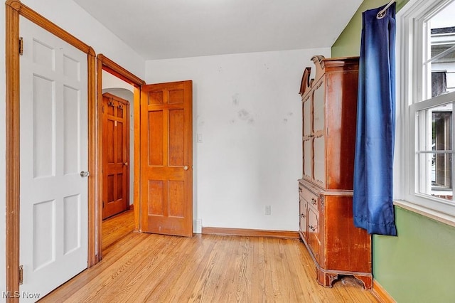 23267 Marion Rd, North Olmsted, OH 44070 - spare room with plenty of natural light, arched walkways, baseboards, and light wood-style floors