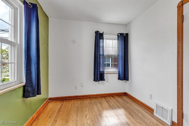 23267 Marion Rd, North Olmsted, OH 44070 - spare room featuring baseboards, wood finished floors, and visible vents