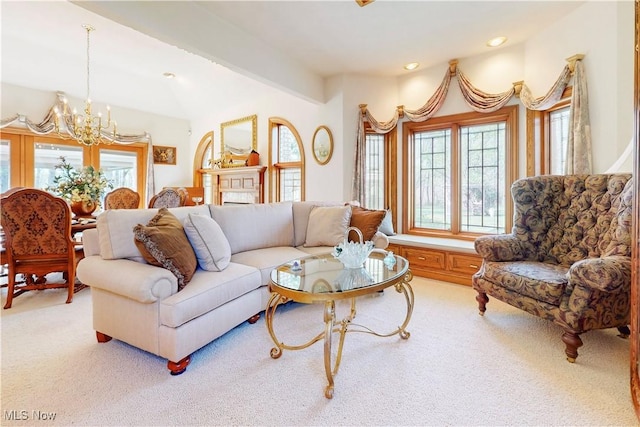 carpeted living area featuring an inviting chandelier
