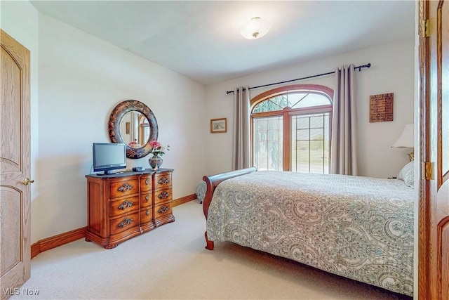 bedroom with carpet floors and baseboards