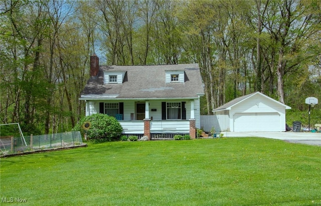 cape cod home featuring a detached garage, fence, an outdoor structure, and a porch