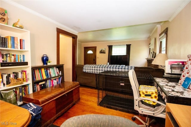 sitting room featuring crown molding and wood finished floors