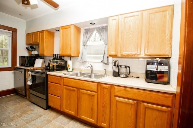 kitchen featuring ceiling fan, appliances with stainless steel finishes, a sink, light countertops, and ornamental molding