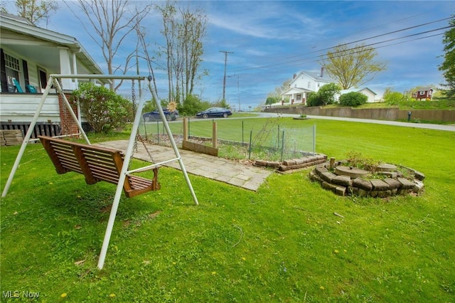 view of playground with a yard and fence