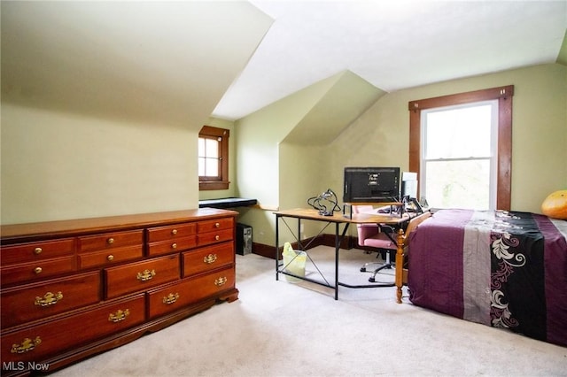 office area with baseboards, light carpet, and lofted ceiling