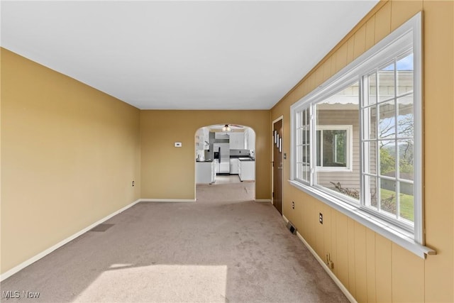 23 Walnut St, Rayland, OH 43943 - carpeted spare room with a healthy amount of sunlight, baseboards, arched walkways, and visible vents
