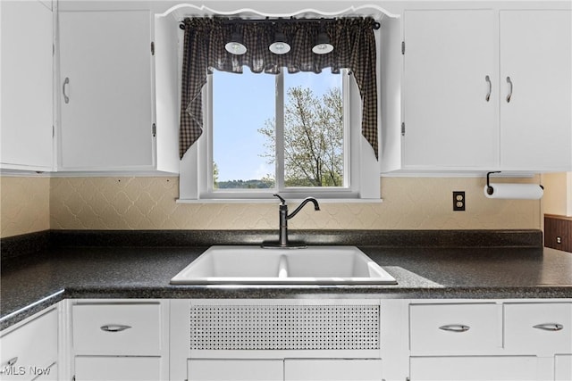 23 Walnut St, Rayland, OH 43943 - kitchen with a sink, white cabinets, dark countertops, and tasteful backsplash