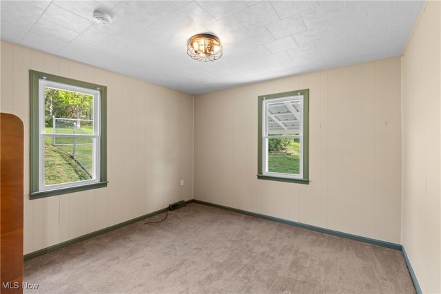 23 Walnut St, Rayland, OH 43943 - carpeted spare room with wooden walls, baseboards, and visible vents