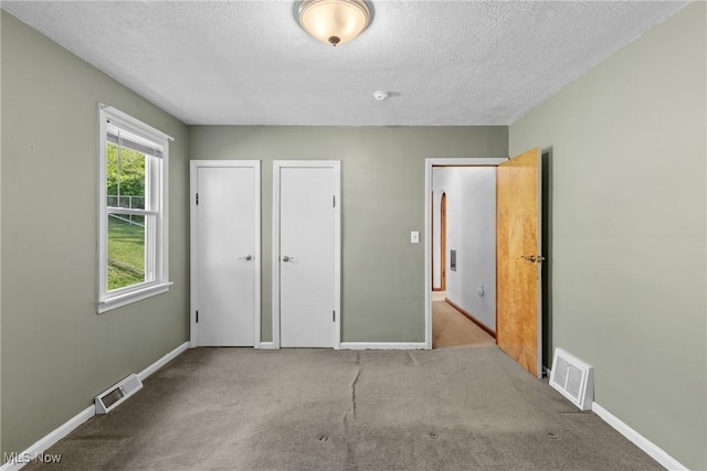 23 Walnut St, Rayland, OH 43943 - unfurnished bedroom with carpet, a textured ceiling, and visible vents