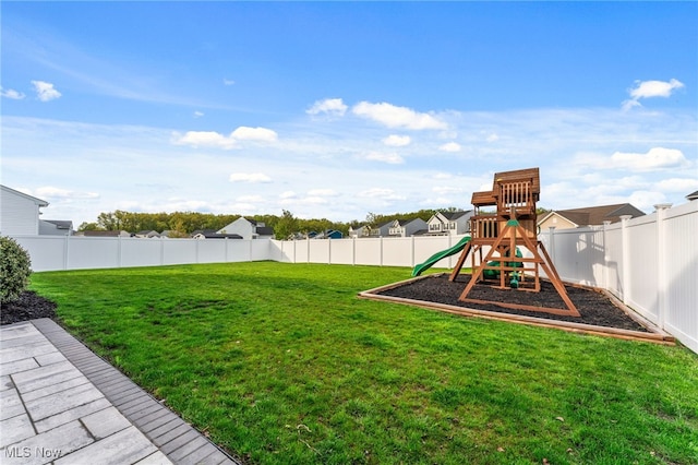 view of yard featuring a playground and a fenced backyard