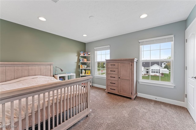bedroom with baseboards, light carpet, and recessed lighting
