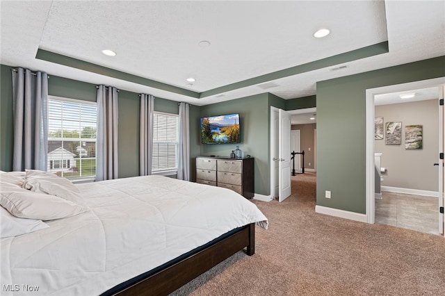 carpeted bedroom featuring recessed lighting, baseboards, and a raised ceiling