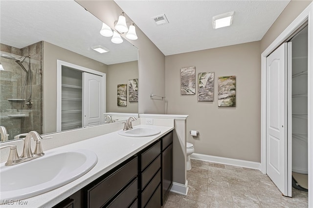 full bath featuring a sink, baseboards, a shower stall, and visible vents