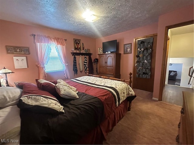 carpeted bedroom featuring a textured ceiling